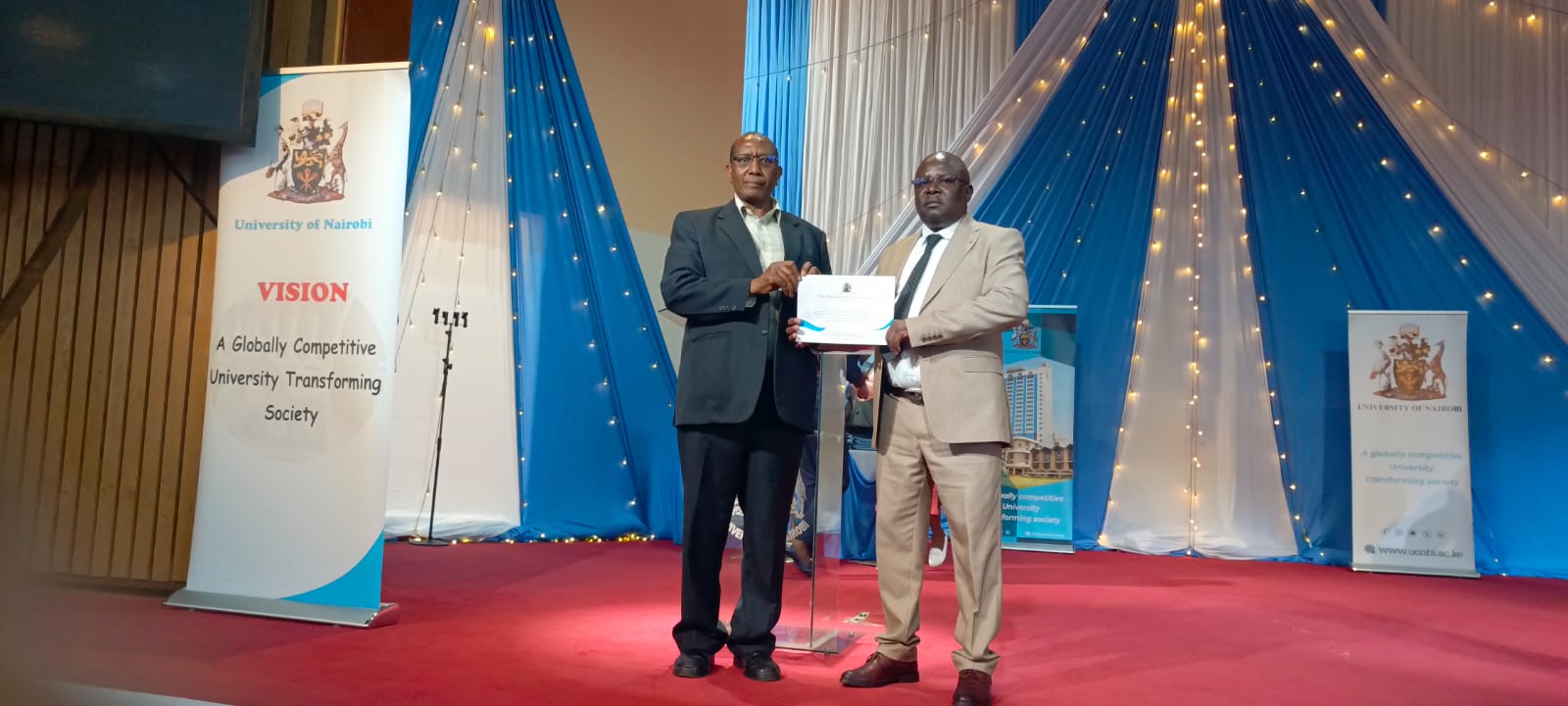 Prof B. N. Ngaruiya and Dr. Peter Mulwa holding an award 